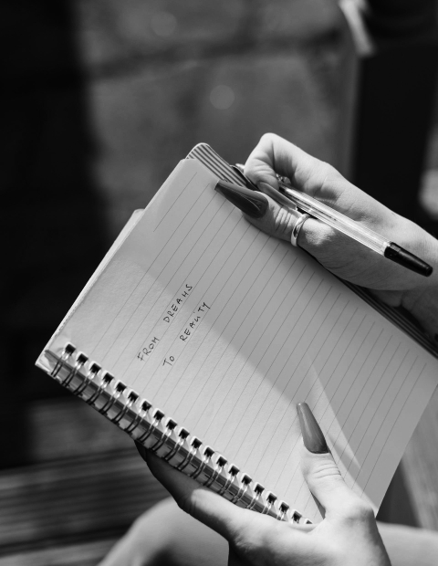 Person holding a notebook.