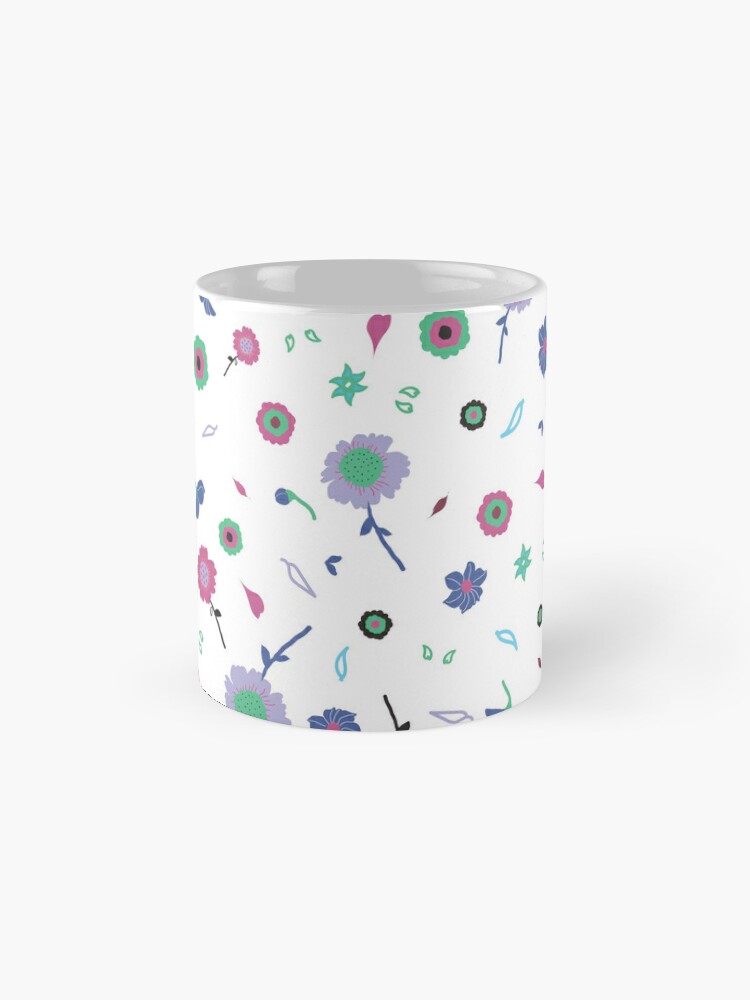 Ceramic flower mug featuring a wraparound white and pink floral pattern design. Designed by Zuzanii Designs.
