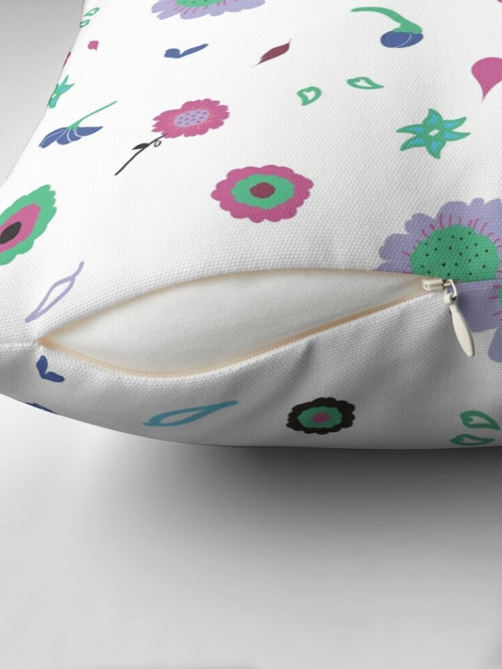 Close-up of concealed zip opening on throw pillow featuring an original white and pink floral pattern, made with a 100% spun polyester cover. One of many floral pillowcases designed by independent artist Zuzanii Designs.