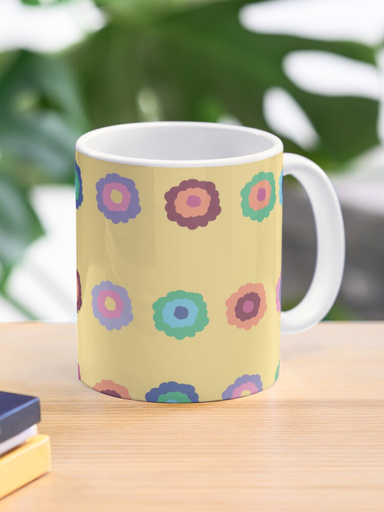 Ceramic flower mug featuring a wraparound bright summer yellow floral pattern design. Designed by Zuzanii Designs.