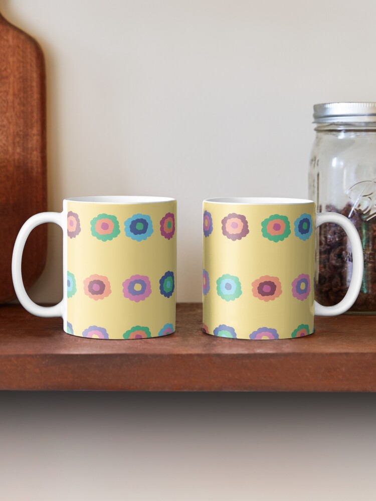 Two ceramic flower mugs featuring a wraparound bright summer yellow floral pattern design. Designed by Zuzanii Designs.