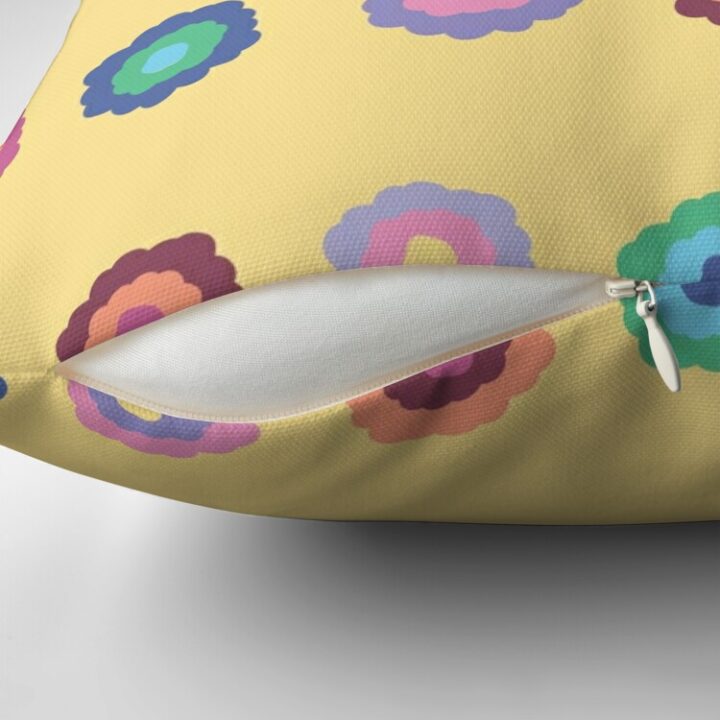 Close-up of concealed zip opening on throw pillow featuring an original bright summer yellow floral pattern, made with a 100% spun polyester cover. One of many floral pillowcases designed by independent artist Zuzanii Designs.