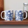 Two ceramic flower mugs featuring a wraparound blue and white floral pattern design. Designed by Zuzanii Designs.