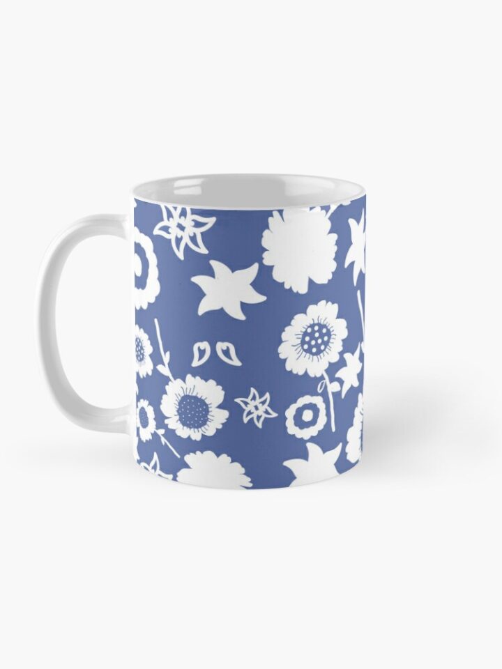 Ceramic flower mug featuring a wraparound blue and white floral pattern design. Designed by Zuzanii Designs.