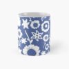 Ceramic flower mug featuring a wraparound blue and white floral pattern design. Designed by Zuzanii Designs.