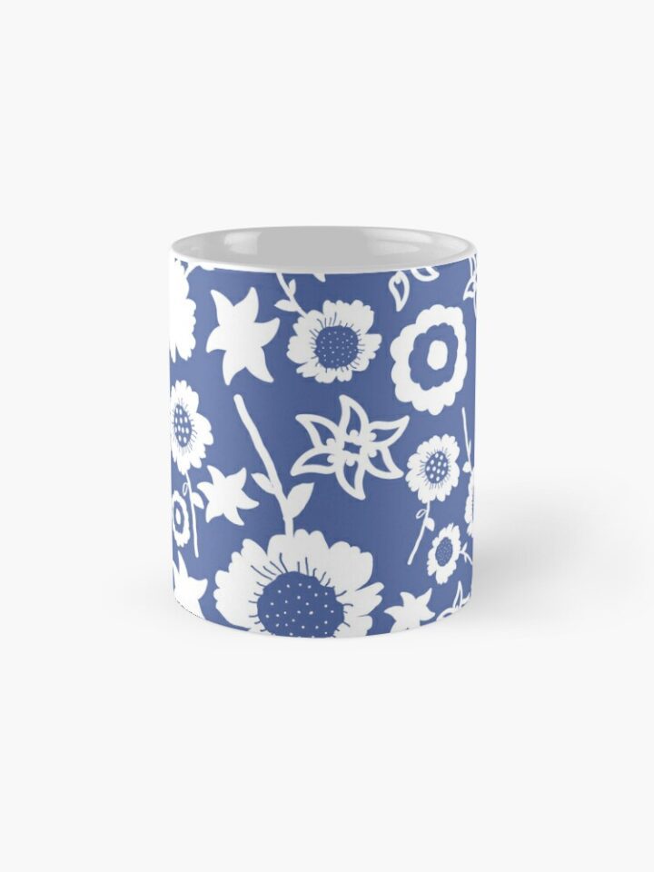 Ceramic flower mug featuring a wraparound blue and white floral pattern design. Designed by Zuzanii Designs.