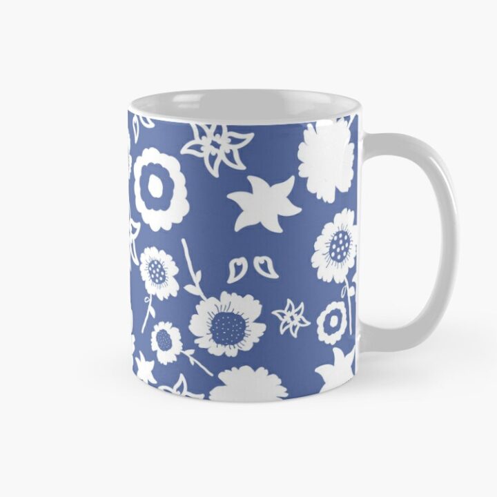 Ceramic flower mug featuring a wraparound blue and white floral pattern design. Designed by Zuzanii Designs.