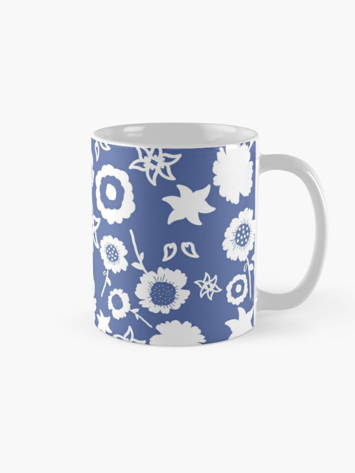 Ceramic flower mug featuring a wraparound blue and white floral pattern design. Designed by Zuzanii Designs.