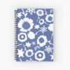 A spiral A5 notebook featuring a blue and white floral front cover print by independent designer Zuzanii Designs.