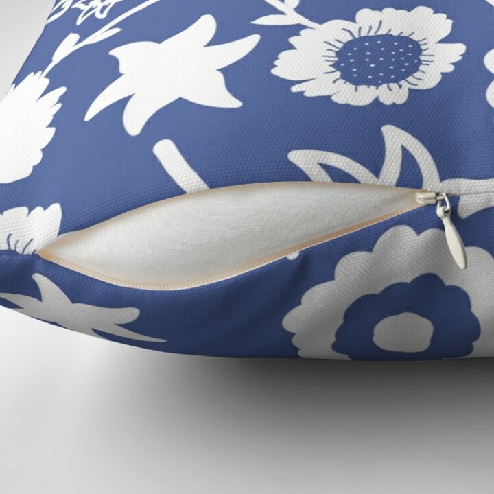 Close-up of concealed zip opening on throw pillow featuring an original blue and white floral pattern, made with a 100% spun polyester cover. One of many floral pillowcases designed by independent artist Zuzanii Designs.