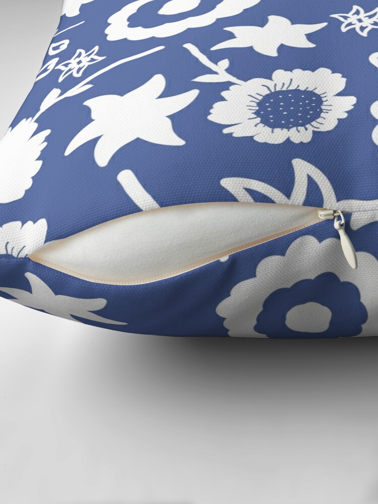 Close-up of concealed zip opening on throw pillow featuring an original blue and white floral pattern, made with a 100% spun polyester cover. One of many floral pillowcases designed by independent artist Zuzanii Designs.