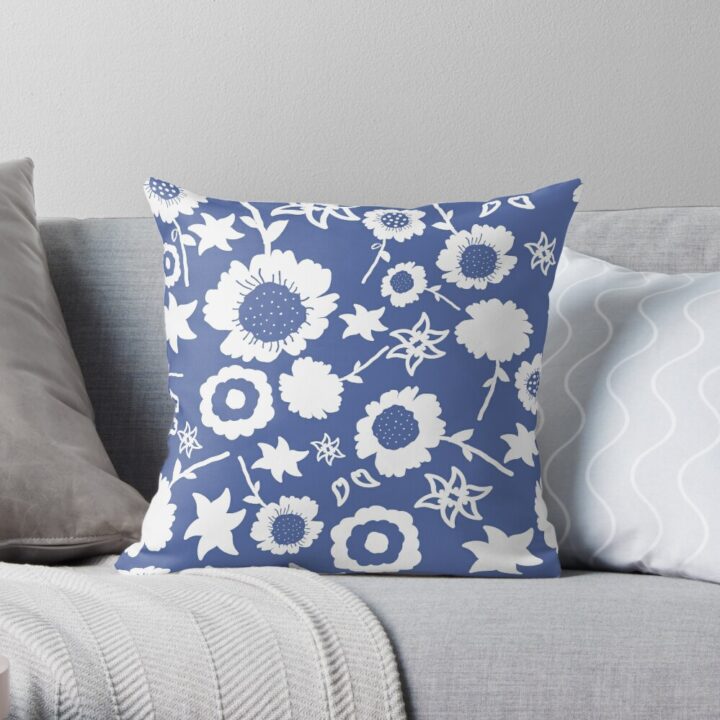 A throw pillow featuring an original blue and white floral pattern, made with a 100% spun polyester cover. One of many floral pillowcases designed by independent artist Zuzanii Designs.