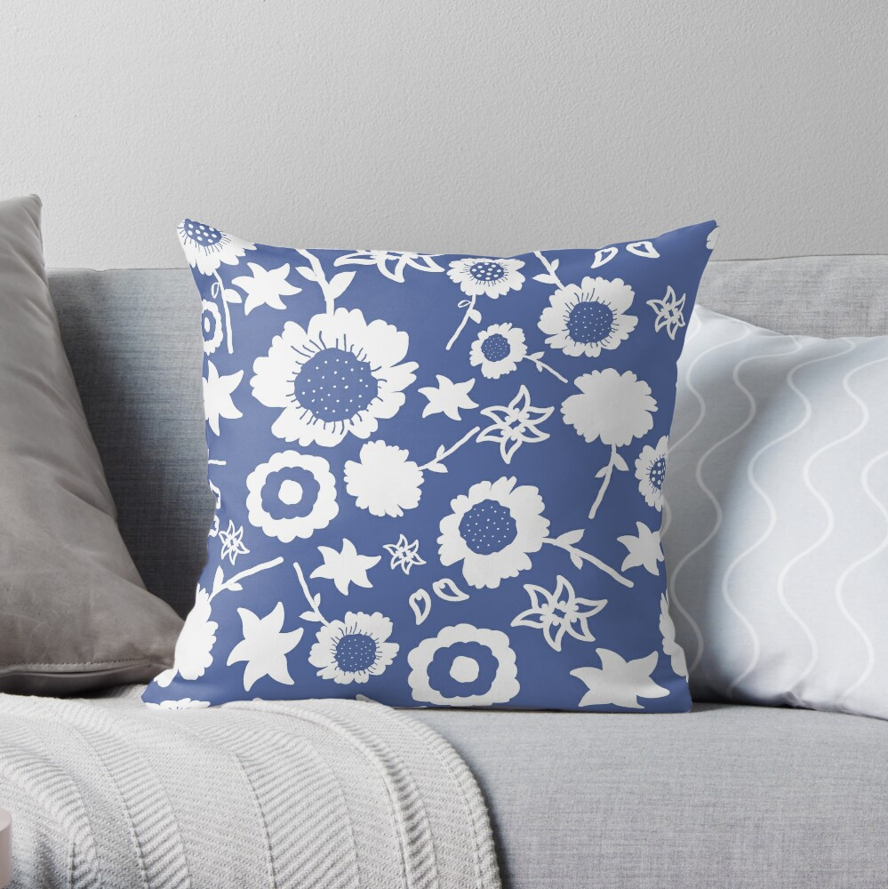 A throw pillow featuring an original blue and white floral pattern, made with a 100% spun polyester cover. One of many floral pillowcases designed by independent artist Zuzanii Designs.