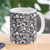 Ceramic flower mug featuring a wraparound black and white floral pattern design. Designed by Zuzanii Designs.