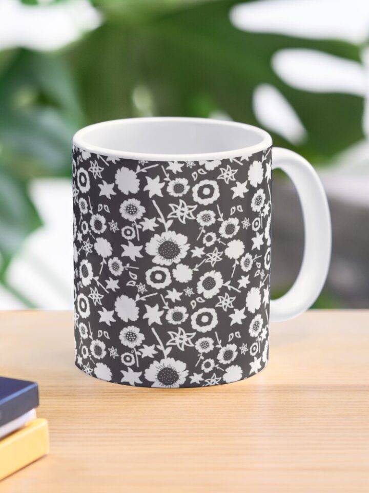 Ceramic flower mug featuring a wraparound black and white floral pattern design. Designed by Zuzanii Designs.