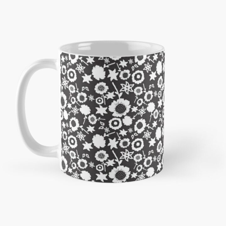 Ceramic flower mug featuring a wraparound black and white floral pattern design. Designed by Zuzanii Designs.