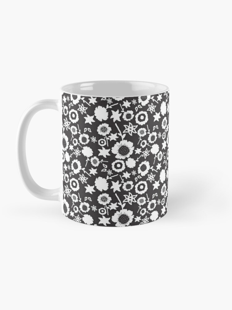 Ceramic flower mug featuring a wraparound black and white floral pattern design. Designed by Zuzanii Designs.