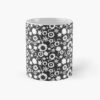 Ceramic flower mug featuring a wraparound black and white floral pattern design. Designed by Zuzanii Designs.