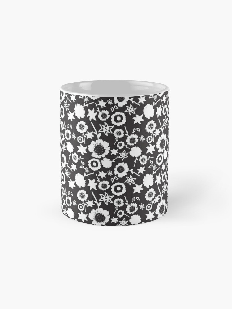 Ceramic flower mug featuring a wraparound black and white floral pattern design. Designed by Zuzanii Designs.