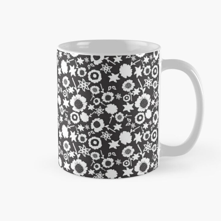 Ceramic flower mug featuring a wraparound black and white floral pattern design. Designed by Zuzanii Designs.