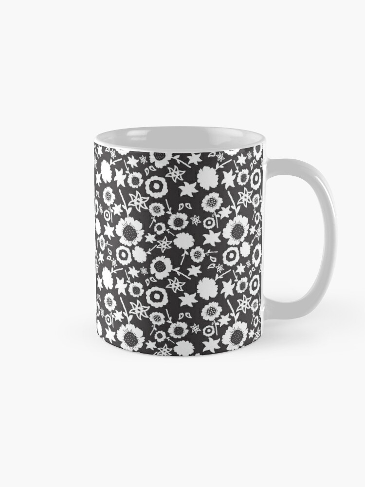 Ceramic flower mug featuring a wraparound black and white floral pattern design. Designed by Zuzanii Designs.