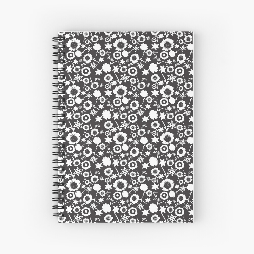 A spiral A5 notebook featuring a black and white floral front cover print by independent designer Zuzanii Designs.
