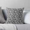 A throw pillow featuring an original black and white floral pattern, made with a 100% spun polyester cover. One of many floral pillowcases designed by independent artist Zuzanii Designs.
