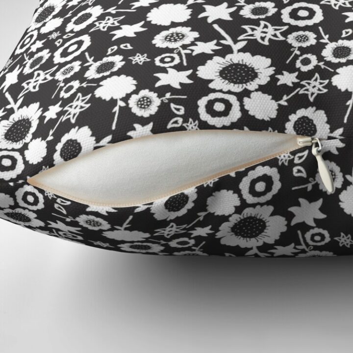 Close-up of concealed zip opening on throw pillow featuring an original black and white floral pattern, made with a 100% spun polyester cover. One of many floral pillowcases designed by independent artist Zuzanii Designs.