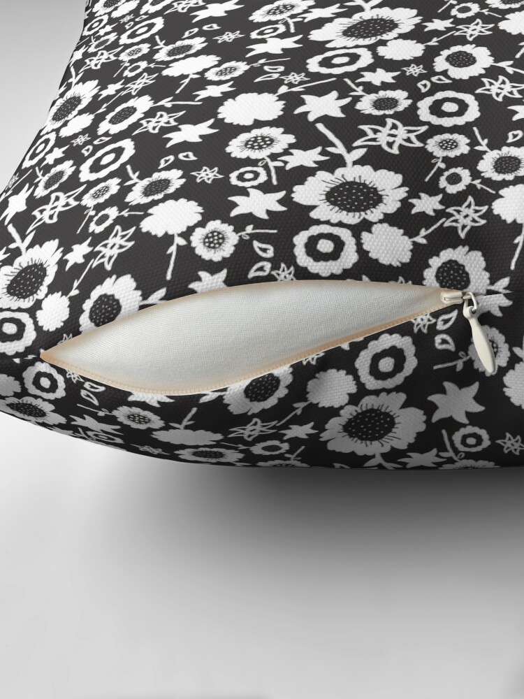 Close-up of concealed zip opening on throw pillow featuring an original black and white floral pattern, made with a 100% spun polyester cover. One of many floral pillowcases designed by independent artist Zuzanii Designs.